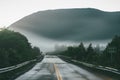 Scenic mountain winding road after the rain. Wet road and steep hills