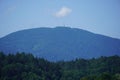 Scenic mountainous landscape featuring a tall radio tower in the center