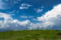 Scenic mountains landscape. White clouds against blue sky with s