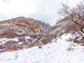 Scenic mountainscape on a winter setting with summit reaching the dense clouds