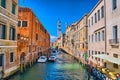 Scenic narrow canal with Carabinieri boats, Venice, Italy, HDR