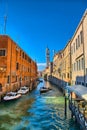 Scenic narrow canal with Carabinieri boats, Venice, Italy, HDR