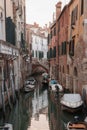 Scenic narrow canal in Venice, Italy with reflections - tranquil and picturesque urban landscape