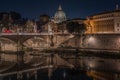 Scenic night cityscape of Rome with the illuminated cupola of St. Peter Basilica