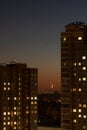 Scenic night view of raising moon over city shot between high-rise buildings Royalty Free Stock Photo