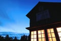 Scenic night view of the summer cottage wih lights in front of the deep blue sky Royalty Free Stock Photo