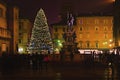 Scenic nightlight landscape view of illuminated Christmas tree near ancient the Fountain of Neptune in Bologna