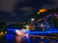 Scenic nightscape of Murinsel bridge on River Mur and illuminated castle in Graz, Austria