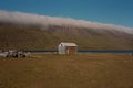 Scenic old hut isolated against a narrow river Royalty Free Stock Photo