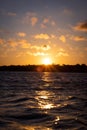 Scenic orange sunset and pretty clouds over a seascape at Charleston harbor Royalty Free Stock Photo