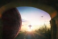 Easter concept: Tomb stone with holy cross and sunset sky background Royalty Free Stock Photo