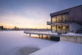 Scenic outdoor winter scene featuring hotel over the frozen lake in Germany at sunset