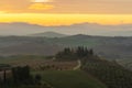 Scenic panorama of the Tuscan landscape with hills and harvest fields in golden morning light, Val d'Orcia, Italy. Royalty Free Stock Photo