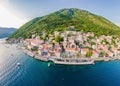 Scenic panorama view of the historic town of Perast at famous Bay of Kotor with blooming flowers on a beautiful sunny Royalty Free Stock Photo