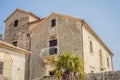 Scenic panorama view of the historic town of Perast at famous Bay of Kotor with blooming flowers on a beautiful sunny Royalty Free Stock Photo