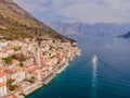 Scenic panorama view of the historic town of Perast at famous Bay of Kotor with blooming flowers on a beautiful sunny Royalty Free Stock Photo
