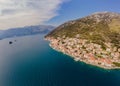 Scenic panorama view of the historic town of Perast at famous Bay of Kotor with blooming flowers on a beautiful sunny Royalty Free Stock Photo