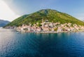 Scenic panorama view of the historic town of Perast at famous Bay of Kotor with blooming flowers on a beautiful sunny Royalty Free Stock Photo