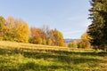 Scenic panoramic view of idyllic rolling hills landscape with blooming meadows and snowcapped alpine mountain peaks in the Royalty Free Stock Photo