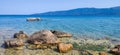 Scenic panoramic view of a tranquil beach surrounded by cliffs in Isthmia, Greece on a summer day