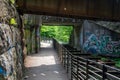 Scenic path under graffiti bridge. Royalty Free Stock Photo