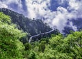 Scenic path winds through a lush forest on the hillside. Trikuta hills in Jammu, India Royalty Free Stock Photo
