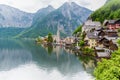 Scenic picture-postcard view of famous Hallstatt mountain village in the Austrian Alps with passenger ship in beautiful morning l Royalty Free Stock Photo