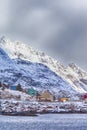 Scenic Picturesque Lofoten Islands with Colorful Small Houses Against Snowy Mountains in Background At Spring Time