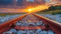 Scenic railway tracks at sunset over rocky terrain Royalty Free Stock Photo