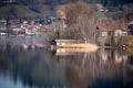 Scenic reflection of a boathouse on an island in lake Schliersee