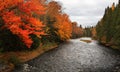 Scenic river with colorful autumn trees on either side in rural Quebec Royalty Free Stock Photo