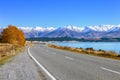 Scenic Road along Lake Tekapo at beautiful sunny morning . Lake Tekapo and mountains with snow in autumn, Canterbury, South Is