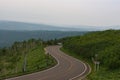 Scenic road bending through the landscapes of Akan National Park