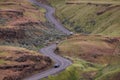 Scenic Road in the Countryside by green farm fields.