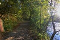 Scenic road near the river with sun rays