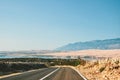 Scenic road by the sea in Croatia leading to Pag, on island, with mountains in the background Royalty Free Stock Photo