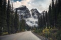 Scenic road trip driving through rocky mountains and pine forest near Moraine Lake at Banff national park Royalty Free Stock Photo