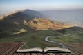 A scenic road winds its way through the Edale Valley on a foggy Winter sunrise in the Peak District in pages of open book, story Royalty Free Stock Photo