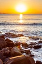 Scenic rocky beach Cala Violina landscape at the sunset. The sun is going down behind the horizon. Tyrrhenian Sea bay at the Royalty Free Stock Photo