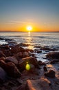 Scenic rocky beach Cala Violina landscape at the sunset. The sun is going down behind the horizon. Tyrrhenian Sea bay at the Royalty Free Stock Photo