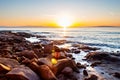 Scenic rocky beach Cala Violina landscape at the sunset. The sun is going down behind the horizon. Tyrrhenian Sea bay at the Royalty Free Stock Photo