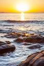 Scenic rocky beach Cala Violina landscape at the sunset. The sun is going down behind the horizon. Tyrrhenian Sea bay at the Royalty Free Stock Photo