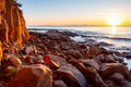 Scenic rocky beach Cala Violina landscape at the sunset. The sun is going down behind the horizon. Tyrrhenian Sea bay at the Royalty Free Stock Photo