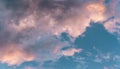 Scenic rose golden glowing big cloud highlighted by Sunset. Close up panoramic aerial photo of deep blue sky with puffy clouds Royalty Free Stock Photo