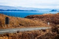 Scenic rural landscape with a long country road near a lake in Isle of Skye, Scotland, UK Royalty Free Stock Photo