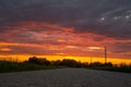 Scenic rural landscape with rural broken dirt road at sunset. Royalty Free Stock Photo