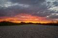 Scenic rural landscape with rural broken dirt road at sunset. Royalty Free Stock Photo