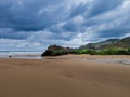 Scenic sandy shore with a small stream of water under a cloudy sky Royalty Free Stock Photo
