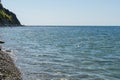 Scenic sea landscape with blue water of Black Sea with rocky coast on the horizon. Olginka village, Tuapse, the Black Sea Royalty Free Stock Photo