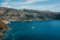 Scenic sea mountains and blue water with sailing boats in Porto Kagio, Mani, Greece
